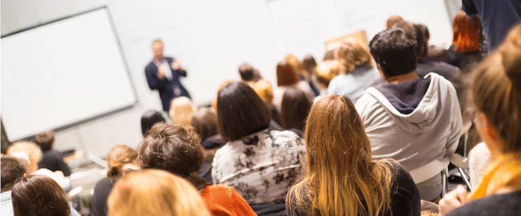 Enda O'Doherty delivering a high impact corporate keynote to a large audience, available for conferences, webinars and seminars across Ireland and the UK