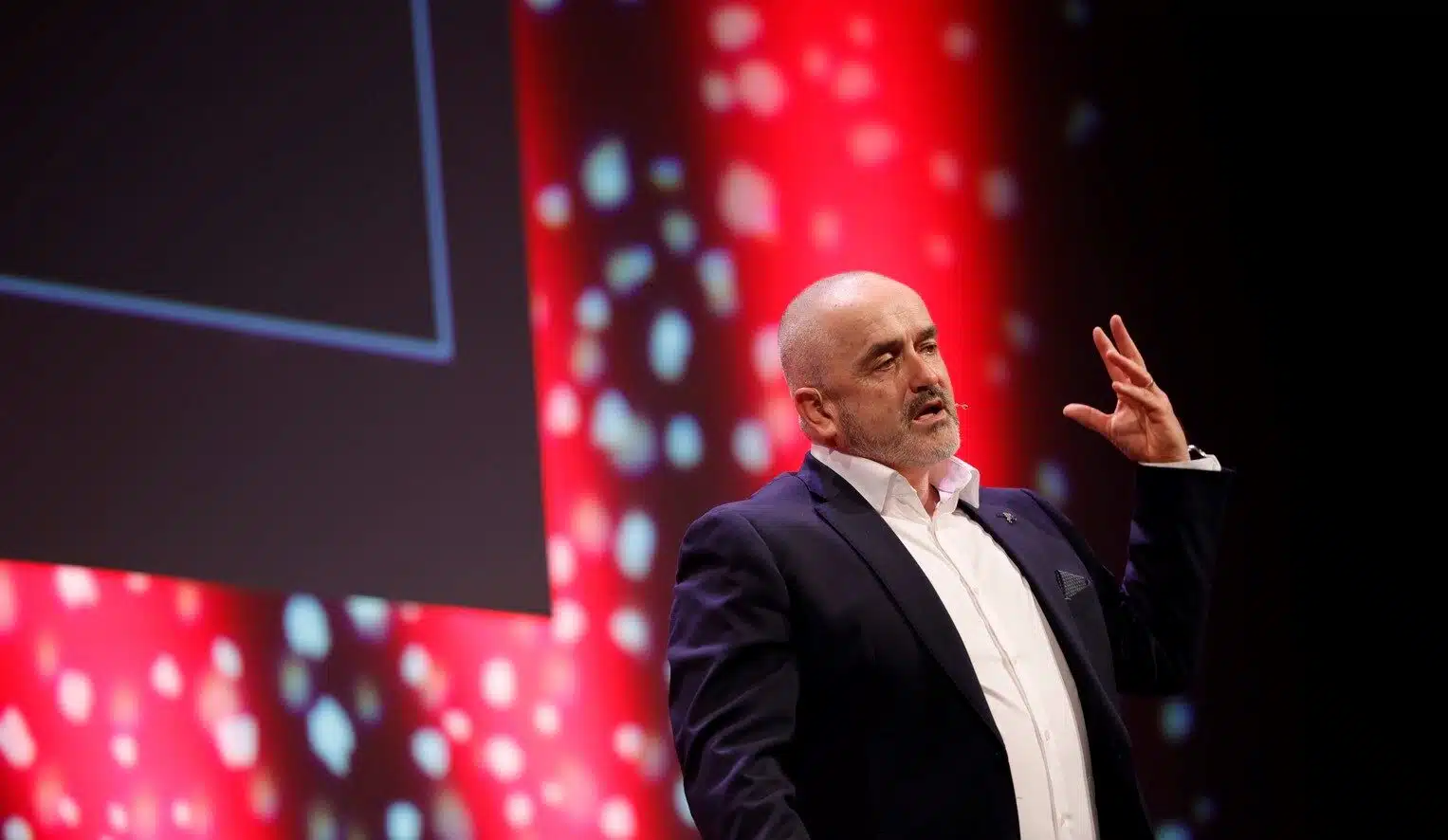 Enda O’Doherty delivering a corporate keynote on stage in Ireland